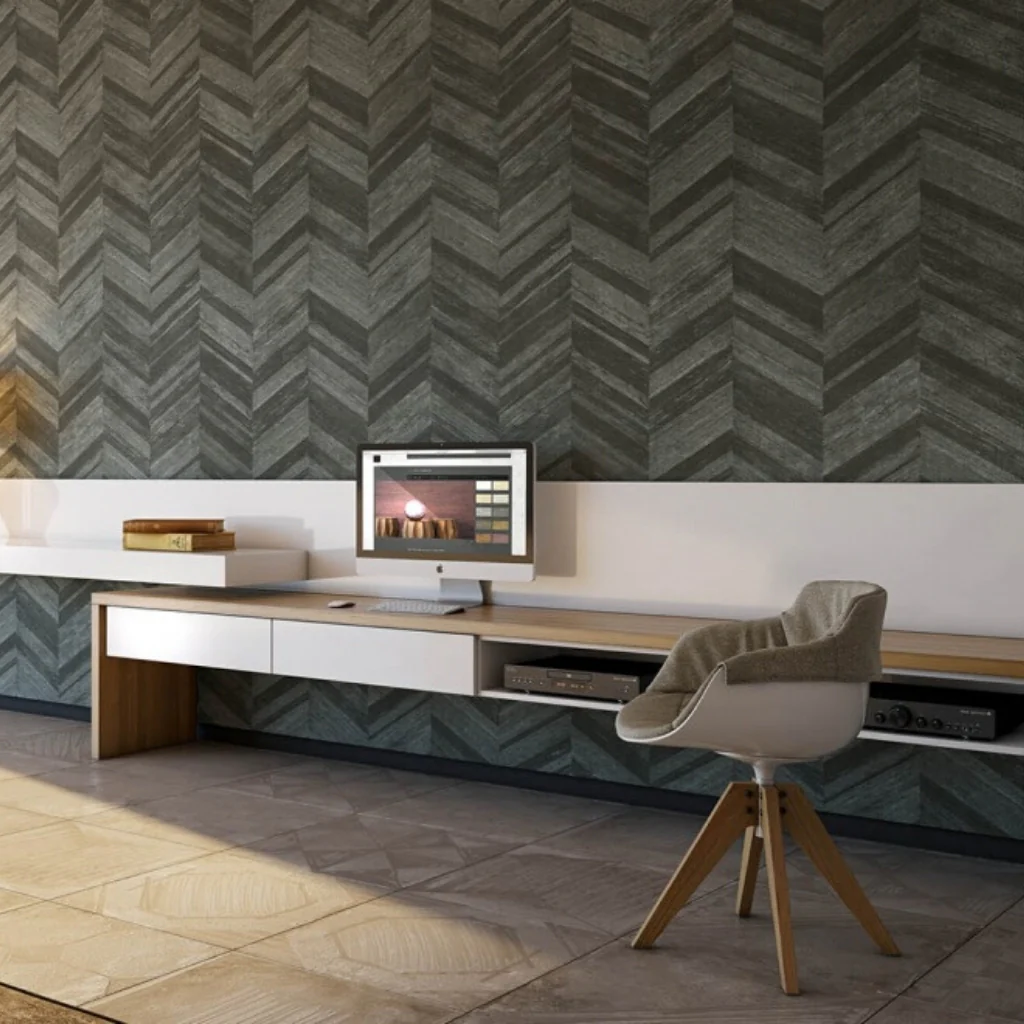 Modern home office with a sleek wooden desk, an iMac computer, a gray chevron-patterned wall, and a comfortable gray chair.