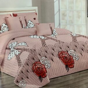 A 5-piece quilt set featuring a whimsical design with the Eiffel Tower surrounded by floral elements, a white bow, and outlined butterflies, all set against a light bold pink background. The charming Parisian theme brings a soft, romantic feel to the bedroom. The set includes a quilt, matching pillow shams, and decorative cushions for a complete and coordinated look.