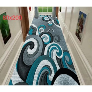 Carpet with a bold curl pattern in blue and white and touches of black.
