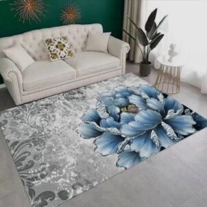 Statement carpet with a bold blue floral design set against a soft grey background, designed to elevate a room.