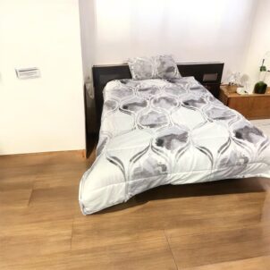Single to three-quarter comforter set , includes one standard pillowcase; made from soft 150gsm microfiber in a white color with a modern pattern in shades of grey for added elegance.