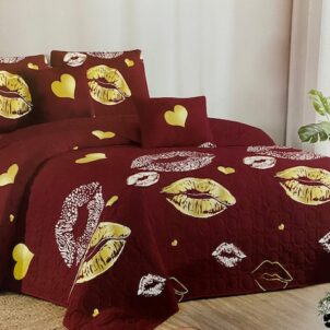 Burgundy quilt featuring yellow and white kissing lips, adding a playful and fun feel to the room.
