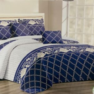 White quilt featuring an elegant navy pattern, offering a crisp and sophisticated look for a refined bedroom setting.