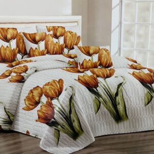 Quilt with a brilliant white background featuring burnt orange flowers, offering a warm and stylish accent to the room