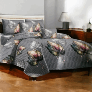 Grey quilt featuring a leaf pattern in warm autumn colors, bringing a cozy and seasonal touch to the room.