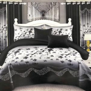 Soft grey quilt featuring a dark grey to black border with a refined floral pattern. The tonal contrast and elegant design lend a sleek, modern feel to the bedding.