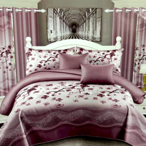 Dusty soft pink quilt adorned with an elegant floral pattern. The gentle tones and refined design create a romantic and soothing ambiance.