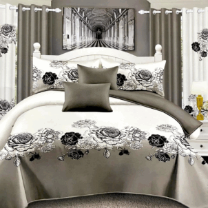 White quilt featuring a delicate floral pattern in shades of white, grey, and black. The monochrome design adds a modern, sophisticated touch to the clean background.