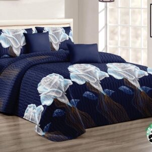 Navy quilt with large, dramatic white lily flowers creating a bold floral contrast.
