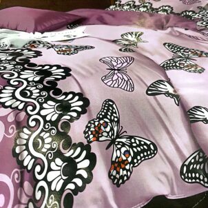 Soft purple bedspread decorated with delicate butterfly patterns, creating a gentle and whimsical look.