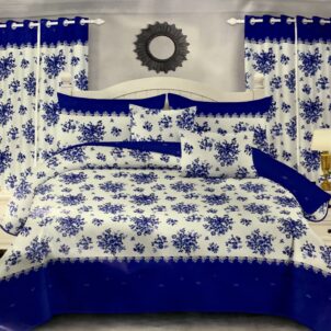 Beautiful white quilt set adorned with soft blue flowers reminiscent of Delft ceramics, creating an elegant and classic look on the bed.