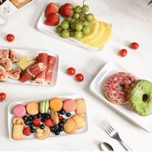 White rectangular ceramic platter with a glossy finish, ideal for serving anything from salads to party food