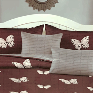 Brownish-red quilt featuring a pattern of butterflies in various colors and sizes.
