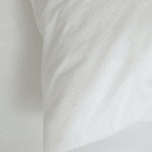 White waterproof pillow protector with a smooth, zippered cover, designed to fit snugly over a standard pillow; provides protection against spills, moisture, and allergens.