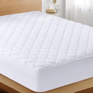 High-quality quilted mattress protector with a soft, textured surface and stitched diamond pattern, fitted neatly over a mattress.