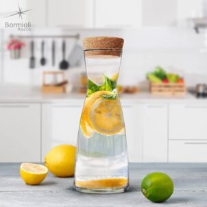 Clear glass juice bottle featuring a natural wooden lid, ideal for storing and serving fresh juices.