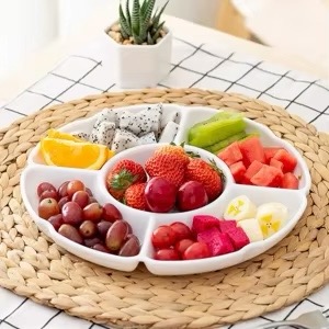 White ceramic serving dish with five neatly divided sections, ideal for presenting a selection of snacks, dips, or small bites.