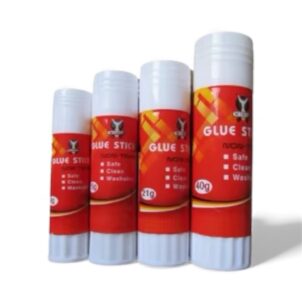 A glue stick on a school desk, part of a collection of back-to-school supplies.