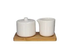 Elegant white sugar jar and creamer set arranged on a natural bamboo tray, ideal for a stylish kitchen or coffee station.